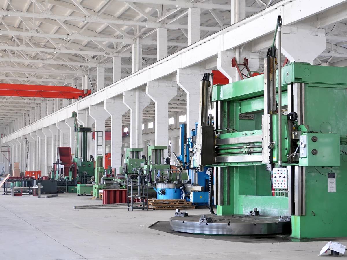 Industrial workshop with green machinery and tools.